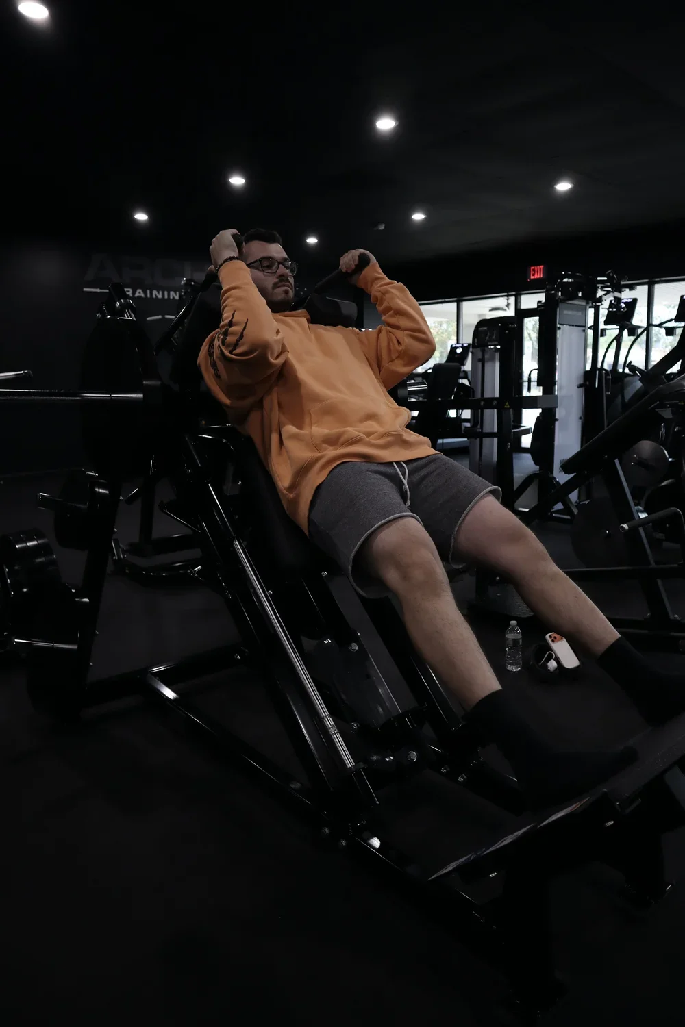 Member squatting a barbell in a rack at ARCH Training Freehold
